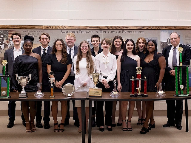debate team with all the of their trophies